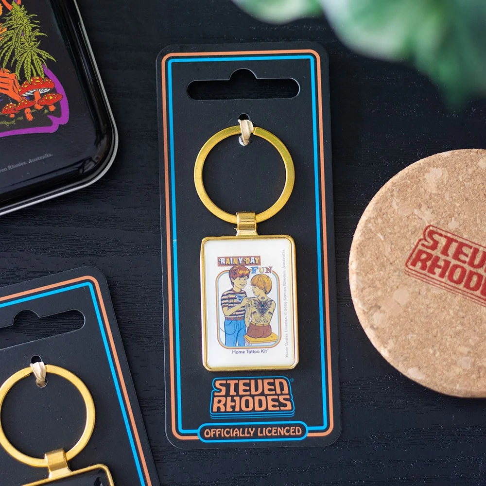 Retro enamel keyring featuring a colorful home tattoo kit design from Steven Rhodes’ Rainy Day Fun collection
