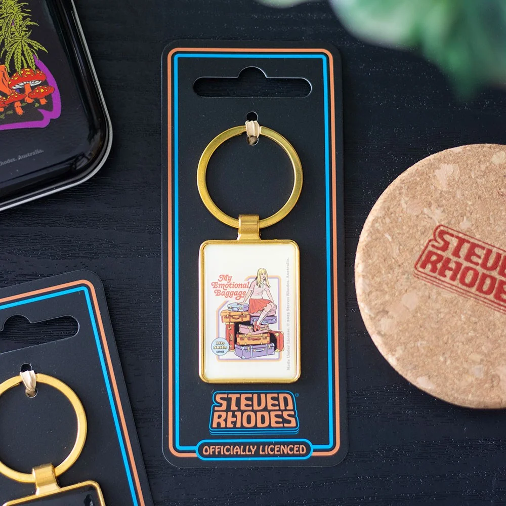 Enamel keyring showing a girl sitting atop colourful luggage symbolising emotional baggage by Steven Rhodes