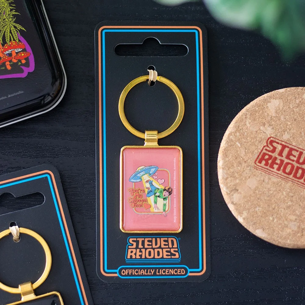 Alien enamel keyring showing a vintage-style flying saucer abducting a person with "You're My Chosen One" text