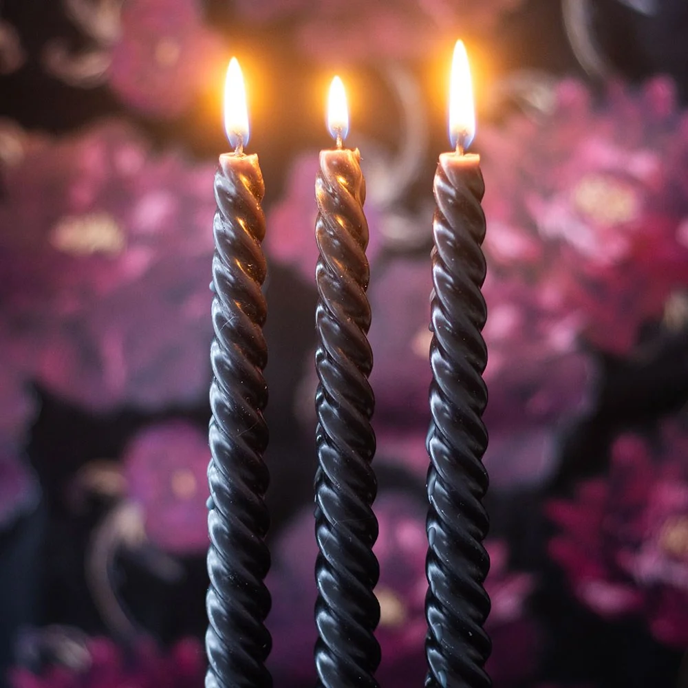 Set of three twisted dark taper candles in rich black, ideal for gothic décor and dramatic candlelit settings