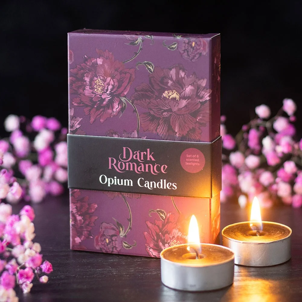 Set of six dark romance opium tealight candles in small round holders with dark botanical packaging on white background