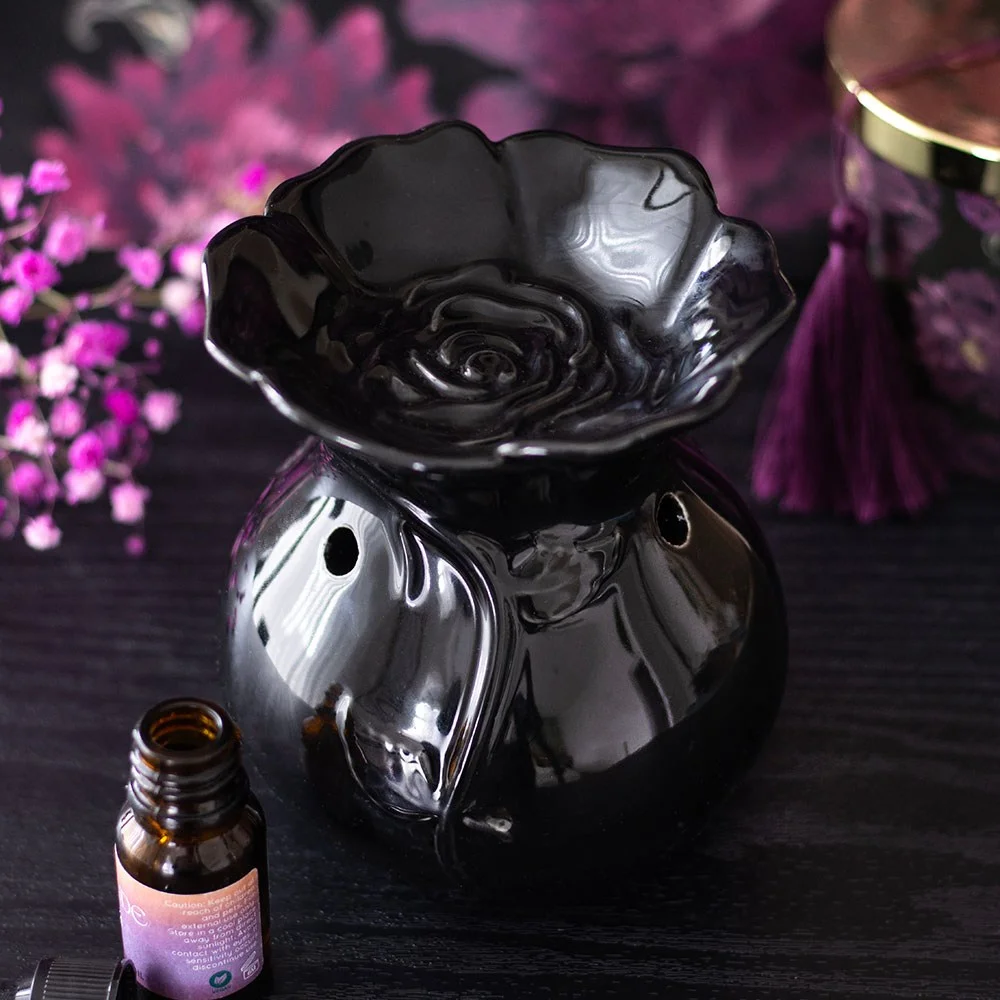 Black ceramic oil burner shaped like a blooming rose with a tealight holder underneath, black rose oil burner design