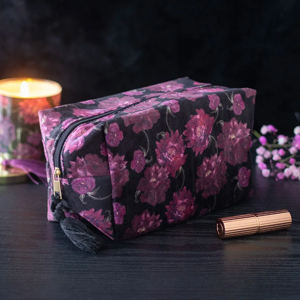 Dark floral makeup bag with elegant gothic-inspired print, rectangular shape, and zipper closure on white background