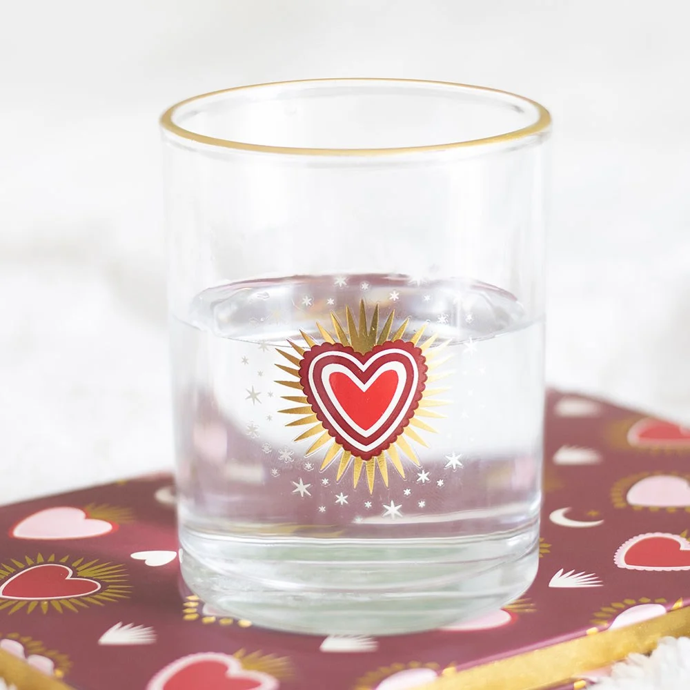 Sacred heart drinking glass with radiant heart design and gold rim, 430ml lowball style on white background