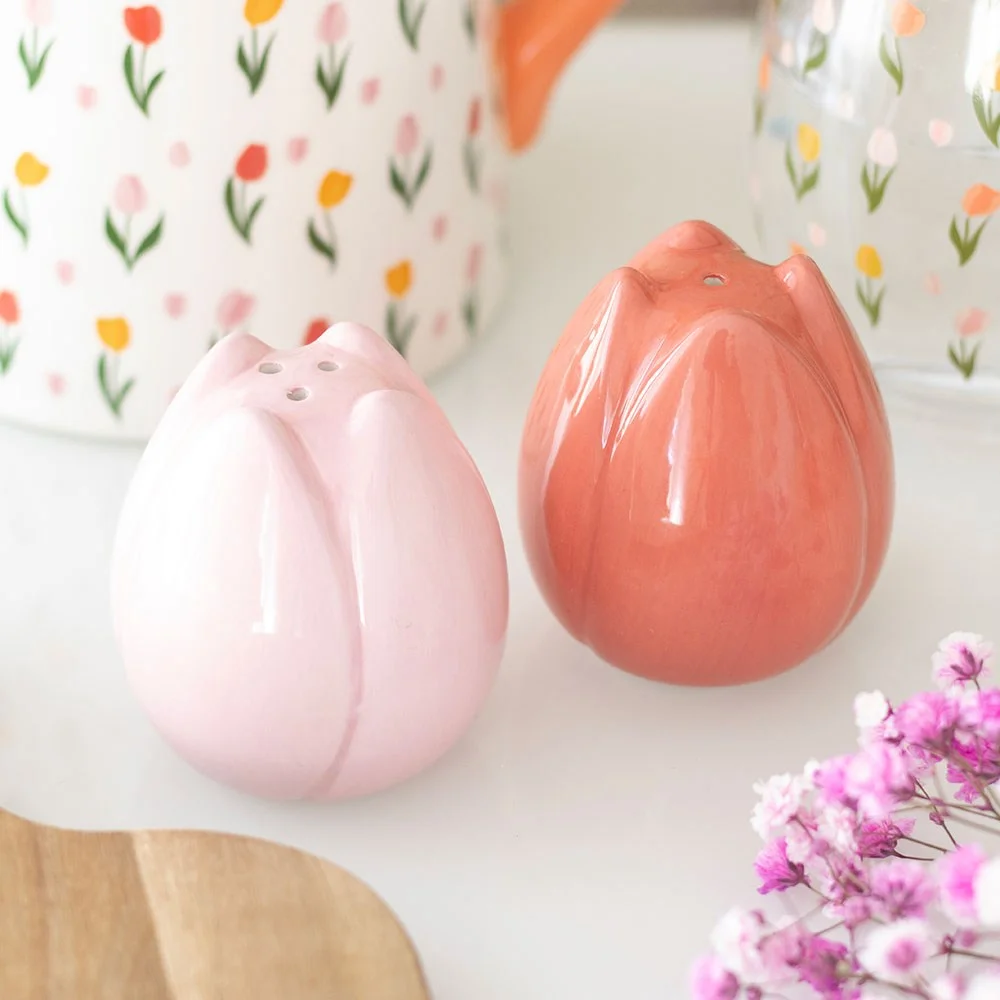 Set of ceramic tulip salt and pepper shakers shaped like pink tulip buds on a white background