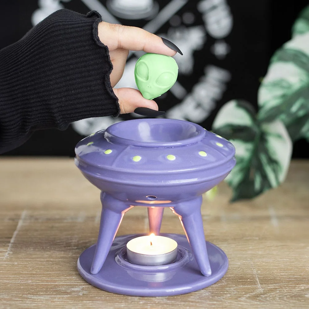UFO wax burner with lime green alien-shaped wax melt on top against a white background