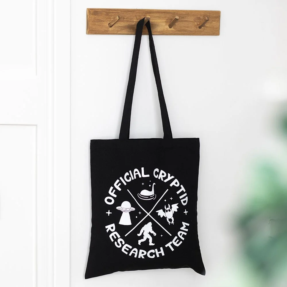 Cryptid Research Team tote bag in polycotton with black text logo, shown flat against white background