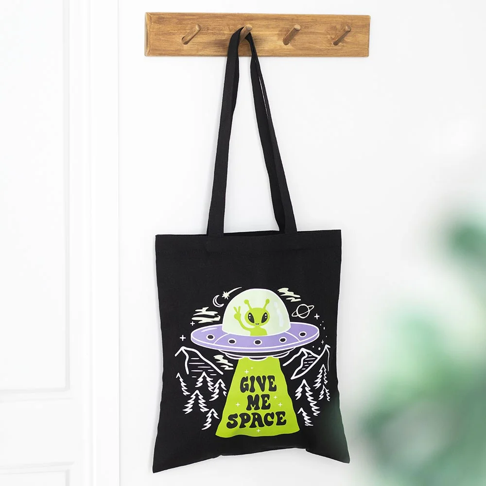 Alien UFO tote bag with a hovering spacecraft and the words Give Me Space on a cream polycotton fabric background