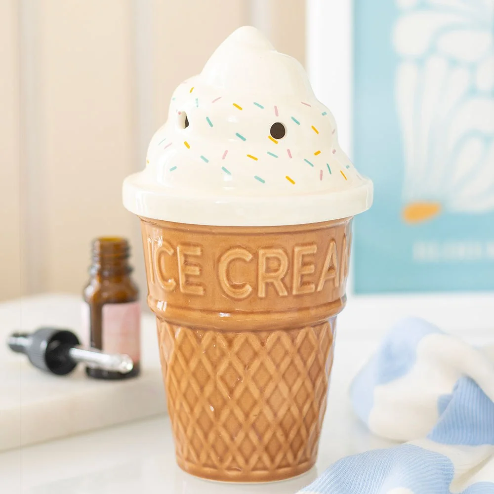 Ceramic oil burner shaped like an ice cream cone with a swirl lid, designed for fragrance oil use with tealight candle