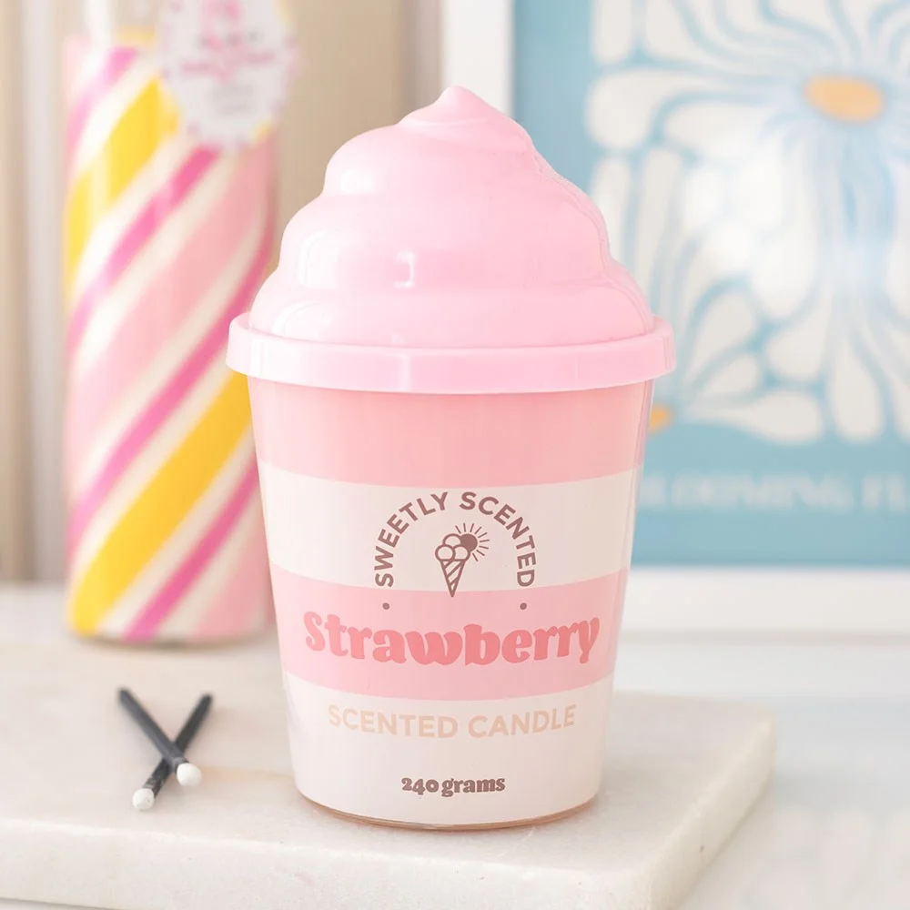 Pink ceramic tub strawberry scented candle with swirled lid, styled like ice cream, on white background