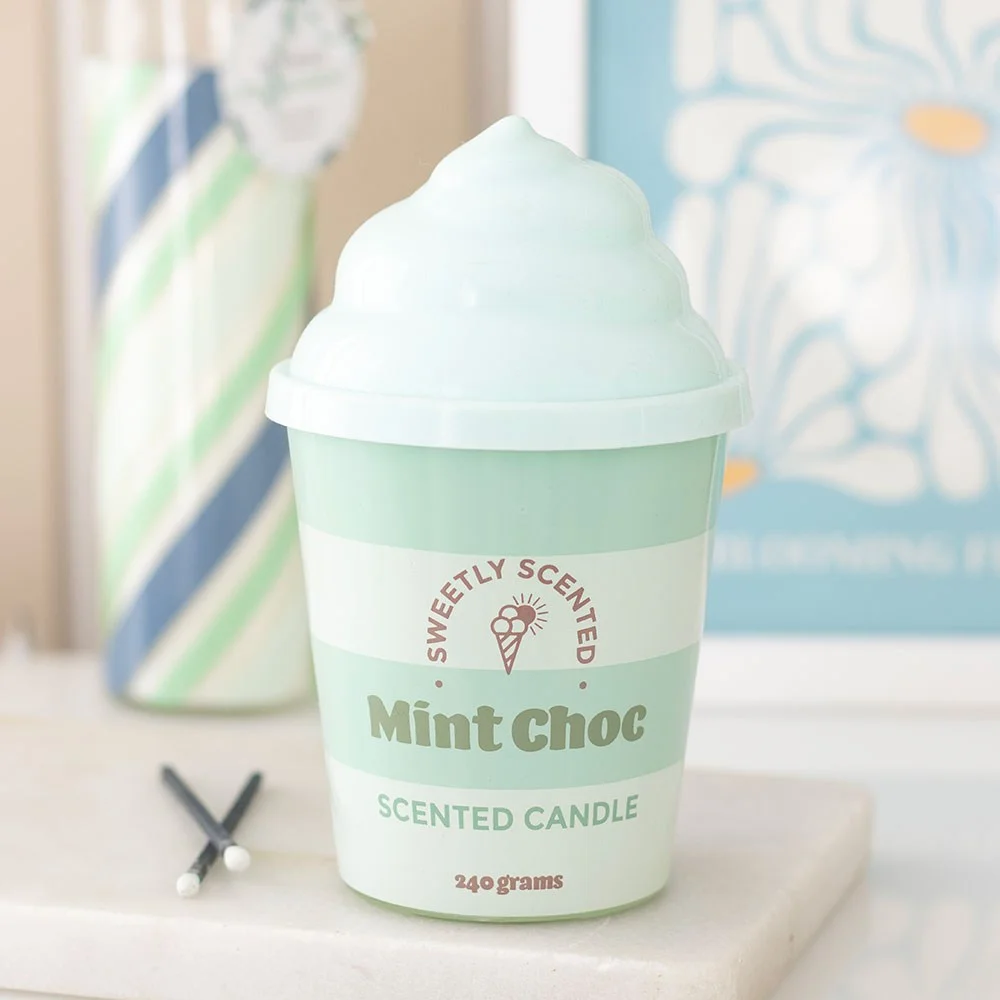 Mint green ceramic tub with swirled silicone lid, mint choc candle styled like ice cream scoop