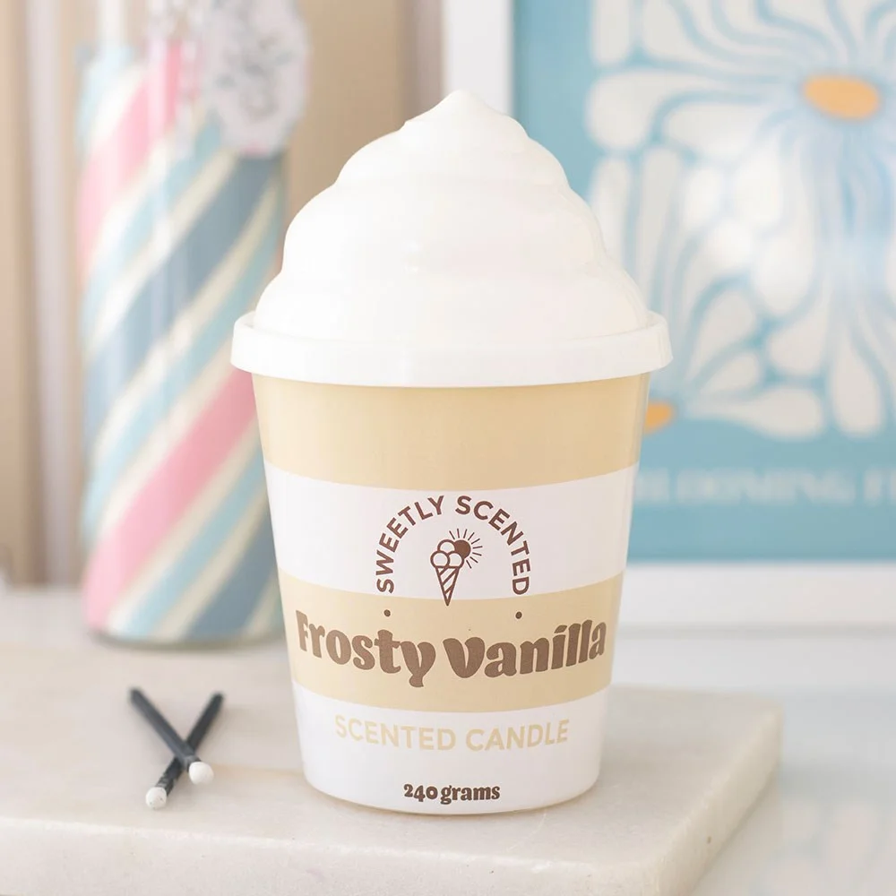 Creamy vanilla scented candle in ceramic tub with swirled lid, styled like frosty ice cream scoop