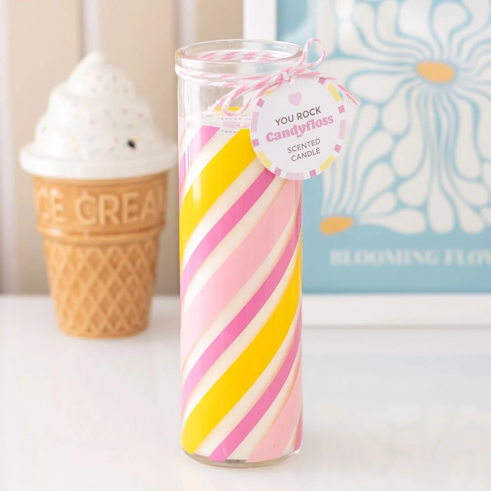 Pink candy stripe candle in glass tube with swing tag reading "You rock," styled like traditional seaside rock candyfloss stick