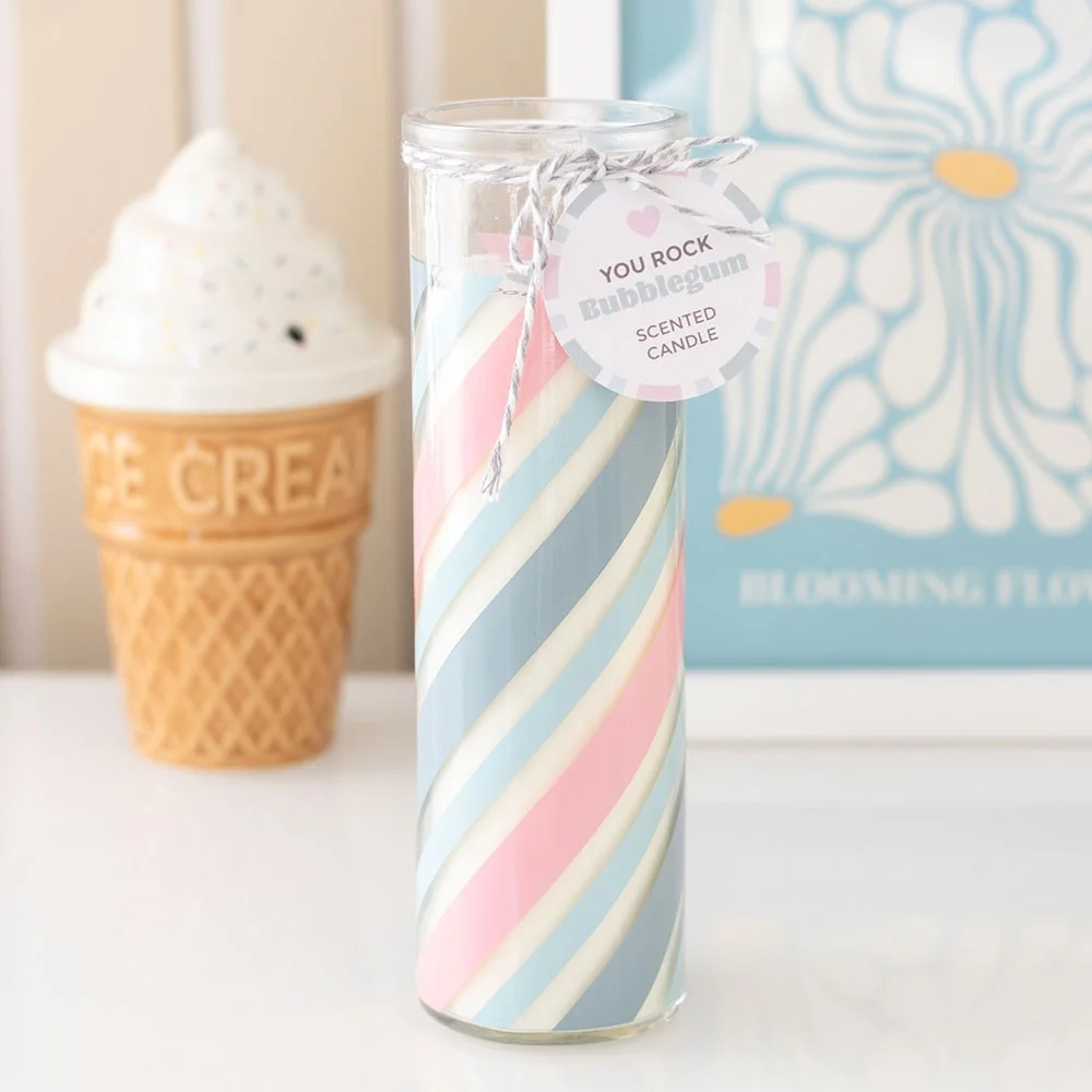 Blue candy stripe candle in a glass tube resembling a classic stick of rock with a swing tag reading You rock
