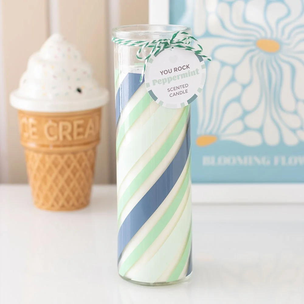 Green candy stripe glass tube peppermint scented candle with swing tag reading You rock on white background