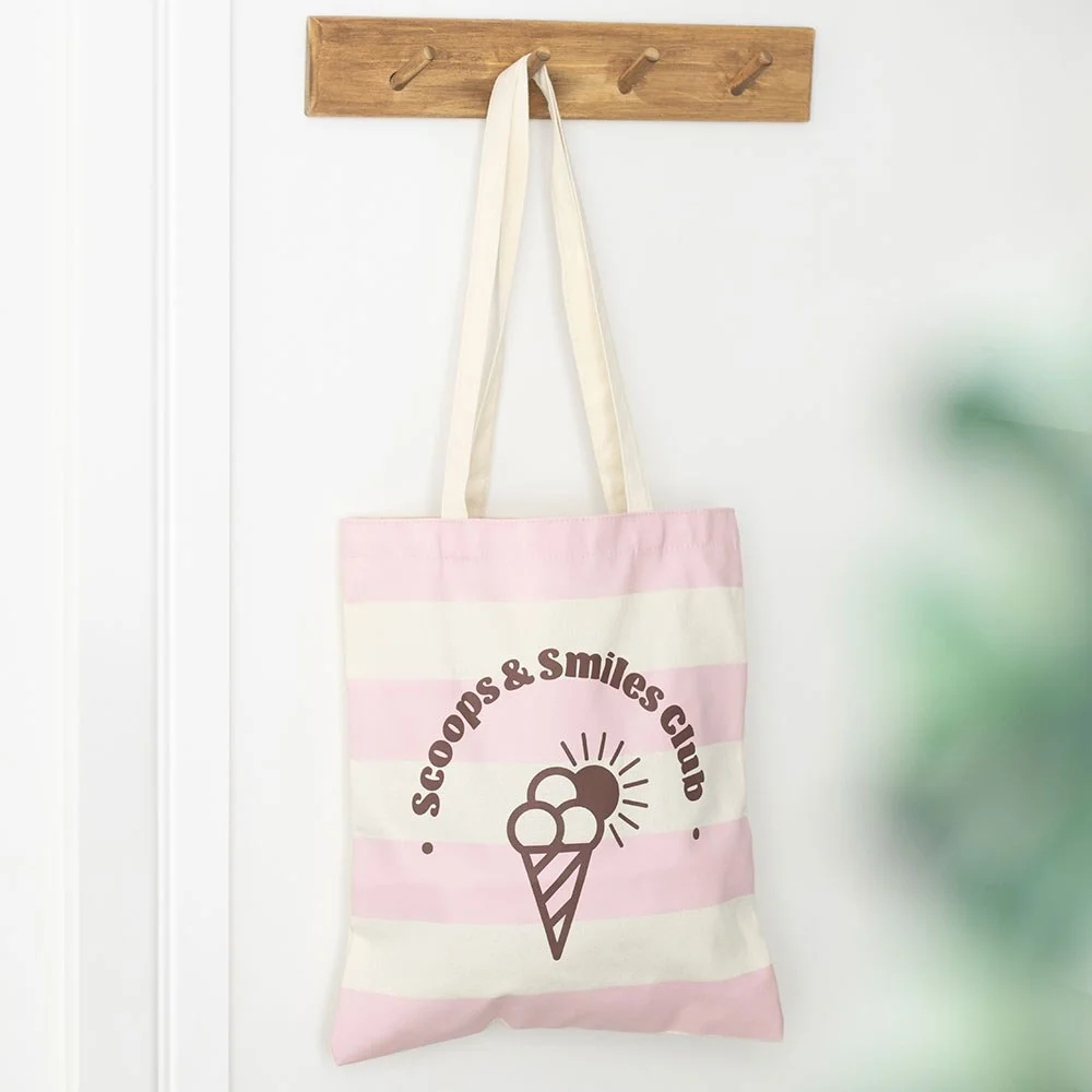Pink tote bag with cheerful ice cream design and Scoops & Smiles Club text, lightweight polycotton fabric