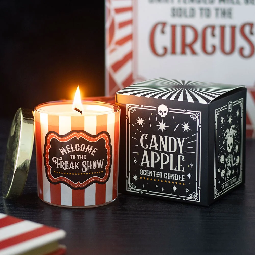 Candy apple scented candle in a red and white striped jar with a 'Welcome to the Freak Show' label.