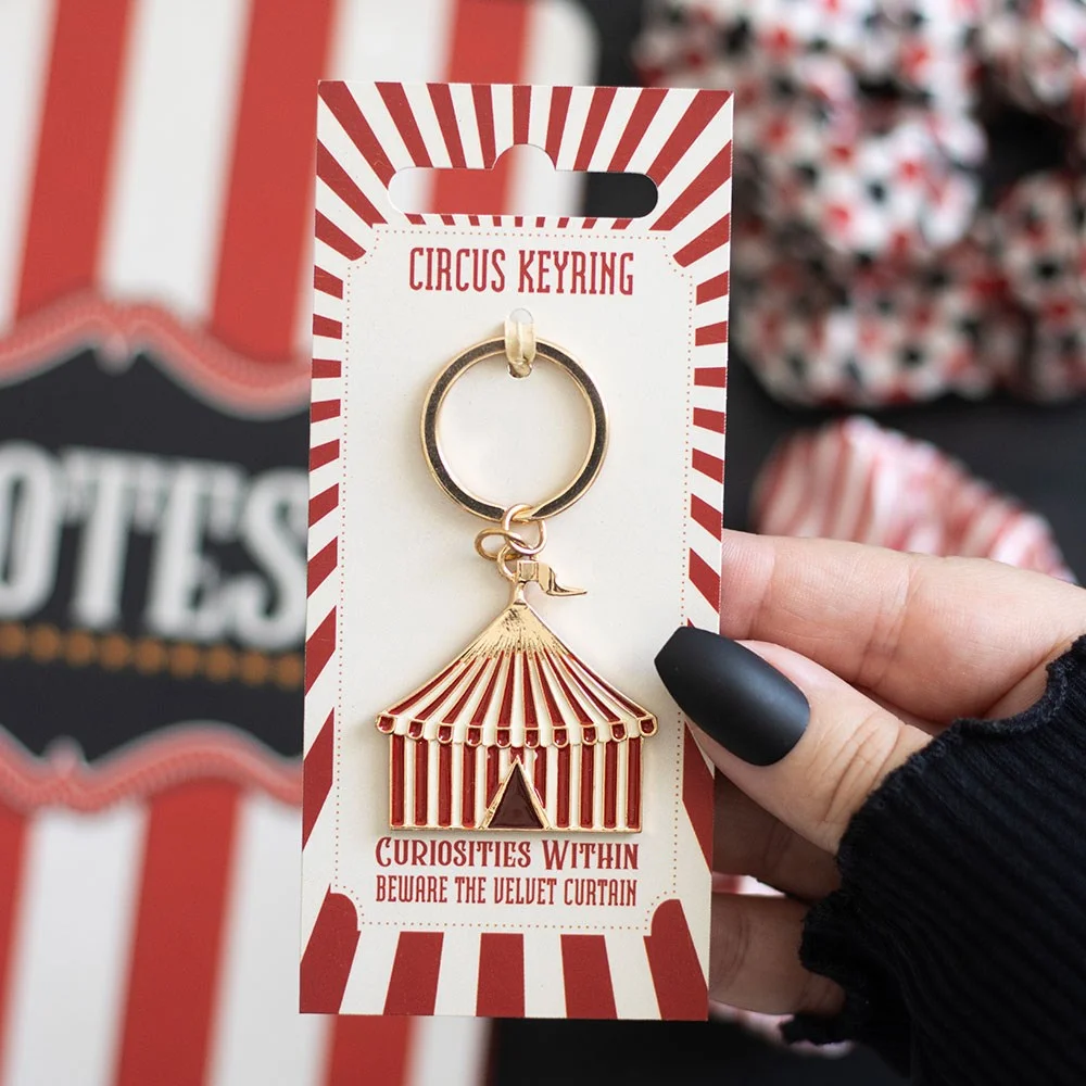 Circus tent keyring with striped enamel tent, bold detail and tiny golden flag on a silver keyring chain