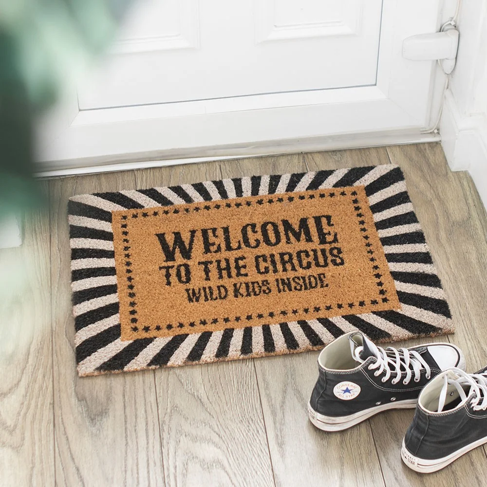 Bold black and white striped circus welcome doormat with text “Welcome to the Circus Wild Kids Inside,” perfect for families.