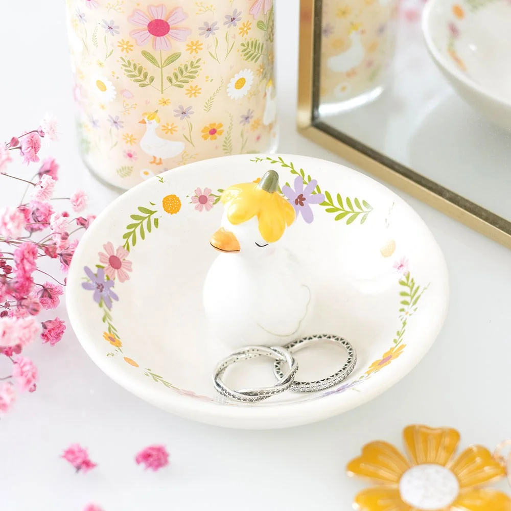 Ceramic trinket dish with a duck figurine wearing a flower hat, ideal for rings and small treasures on a dressing table