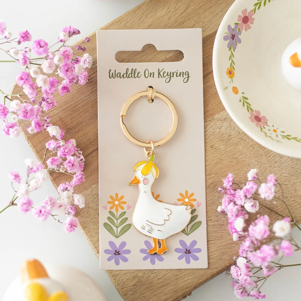 Small alloy and enamel duck keyring with "Waddle On" text, perfect for keys or bags, cute and whimsical design