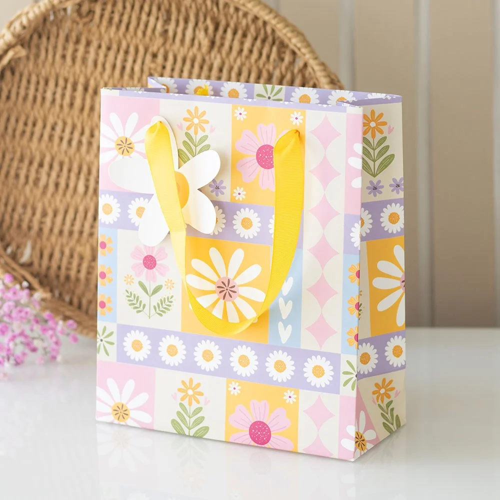 Colourful 23cm floral gift bag with patchwork print, yellow ribbon handles, and daisy gift tag for spring occasions