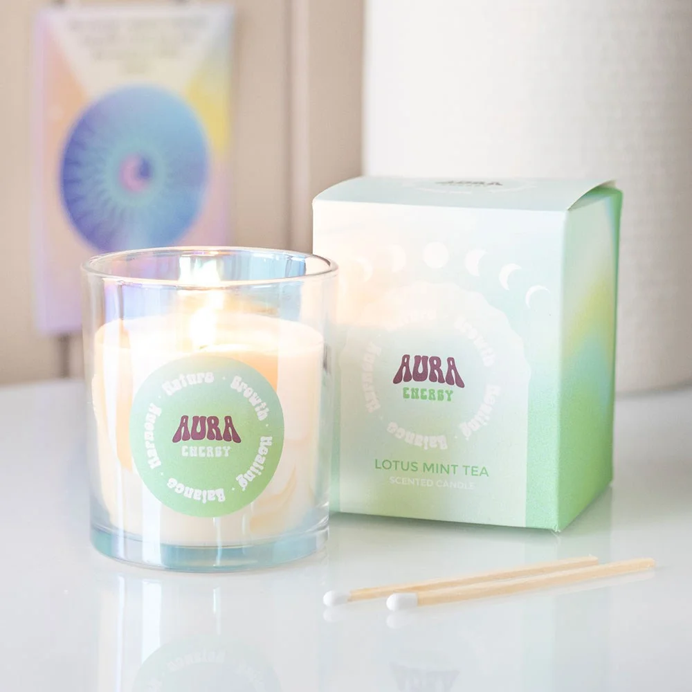 Iridescent glass Lotus Mint Tea candle with shimmering finish and lit wick on white background