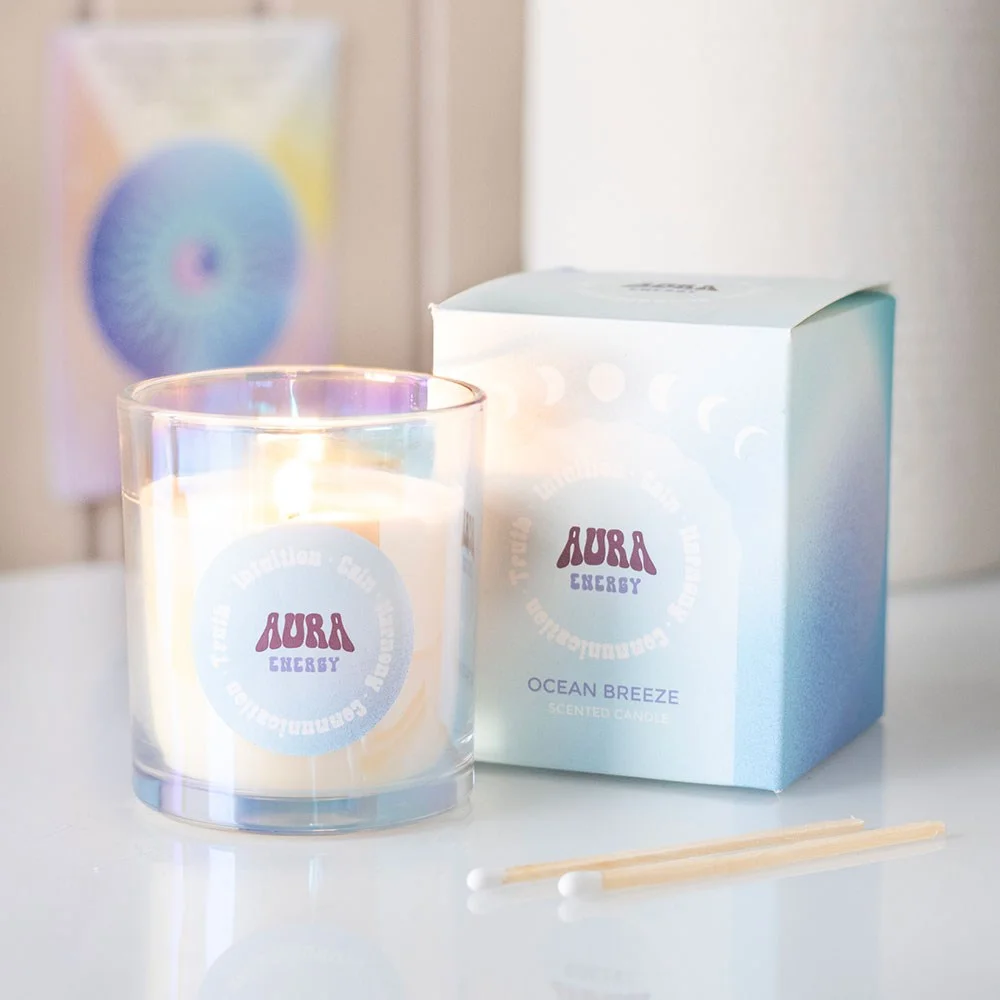 Iridescent glass jar ocean breeze candle with soft glowing light on a white background, 35-hour burn time label visible