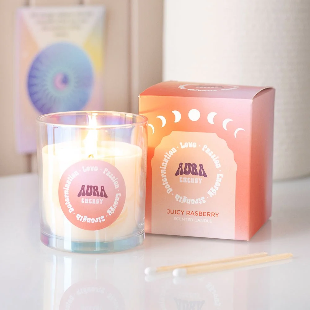Iridescent glass container holding a juicy raspberry candle with vibrant pink wax and subtle shimmer finish