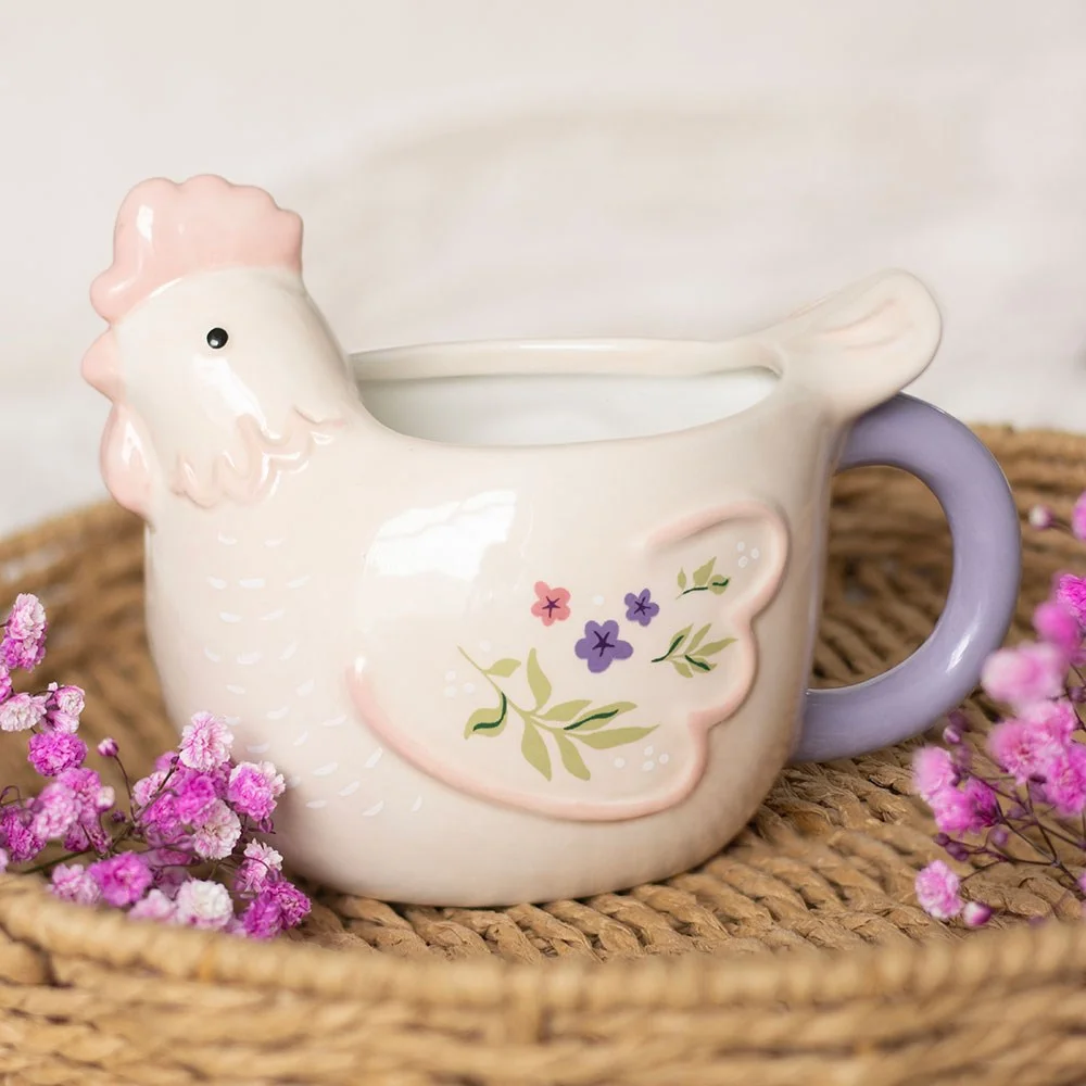 Hen shaped mug in soft pastel colors with floral accents and a lilac handle, 250ml ceramic cup on white background