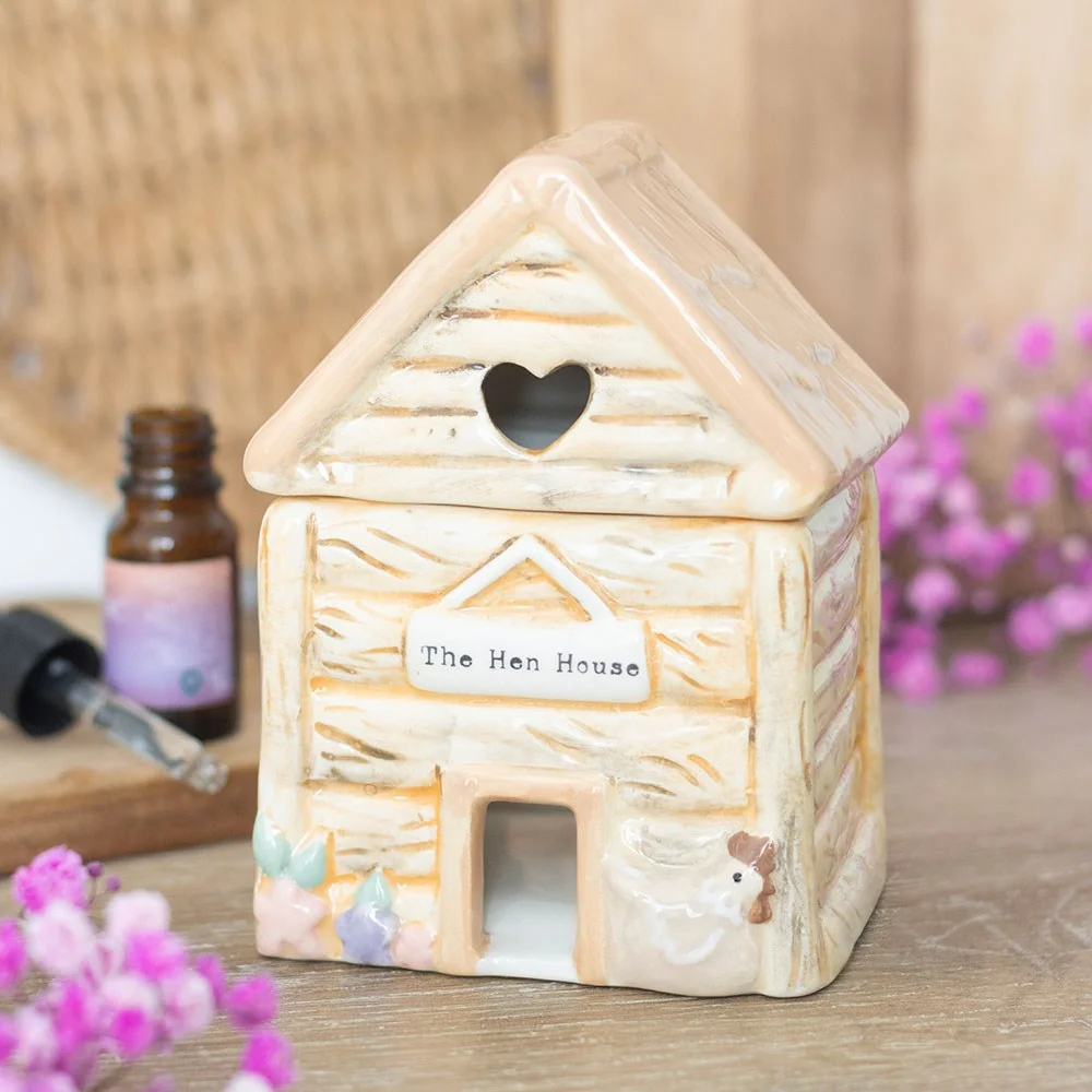 Ceramic oil burner shaped like a pastel hen house with heart cut-out and "The Hen House" sign on front