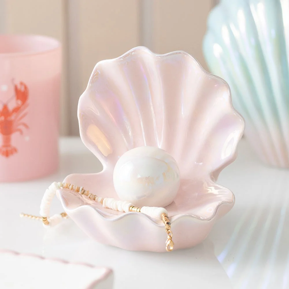 Iridescent pink clam shell trinket dish with a shiny pearl in the centre, ideal for holding rings or small keepsakes