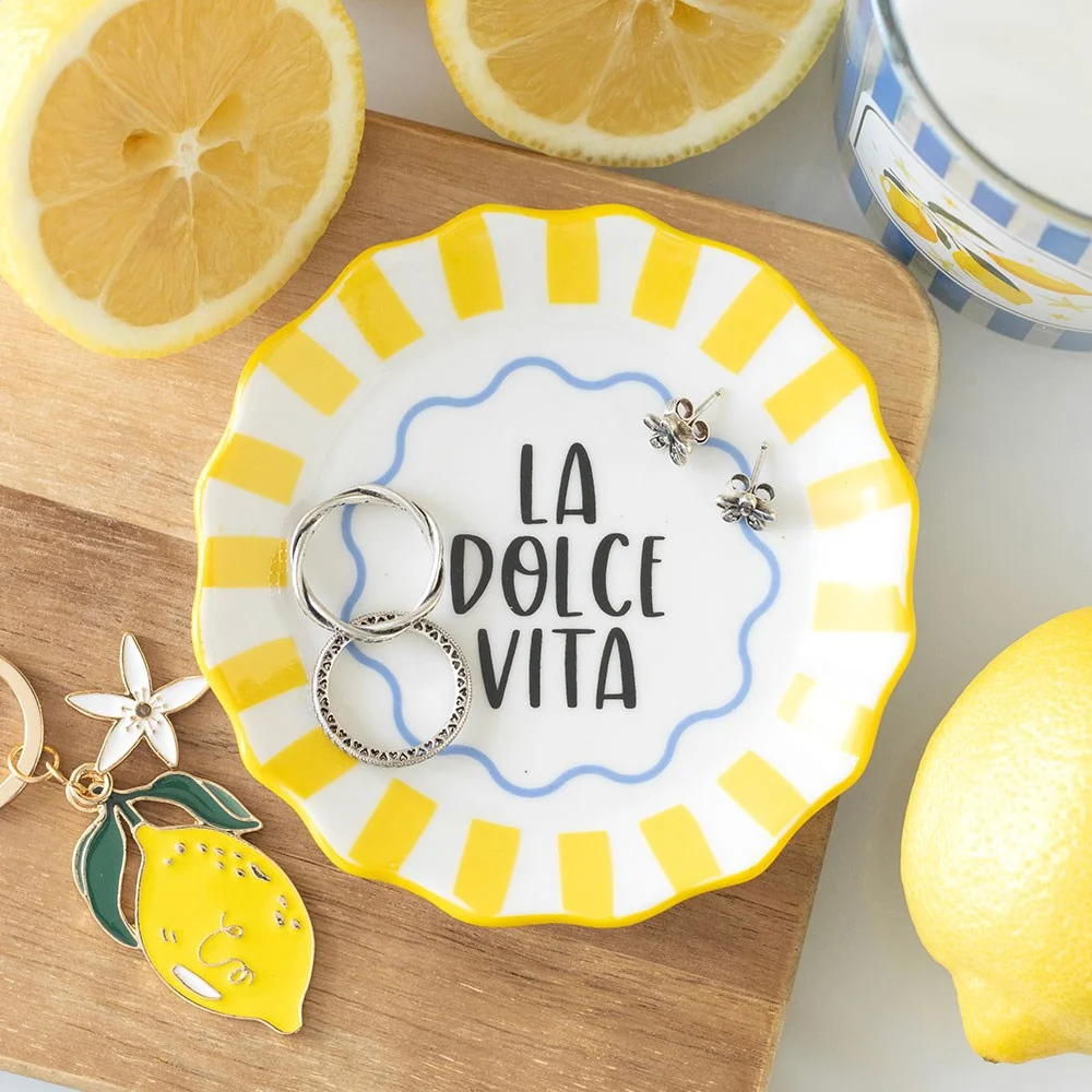 Yellow striped ceramic trinket dish with 'La Dolce Vita' text, perfect for holding small items on tables