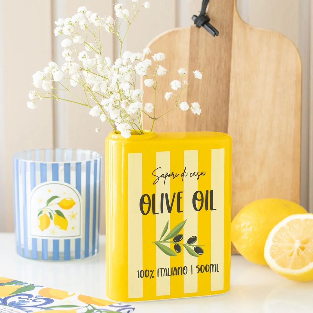Ceramic olive oil vase styled like vintage tin, rustic design with fresh flowers on white background