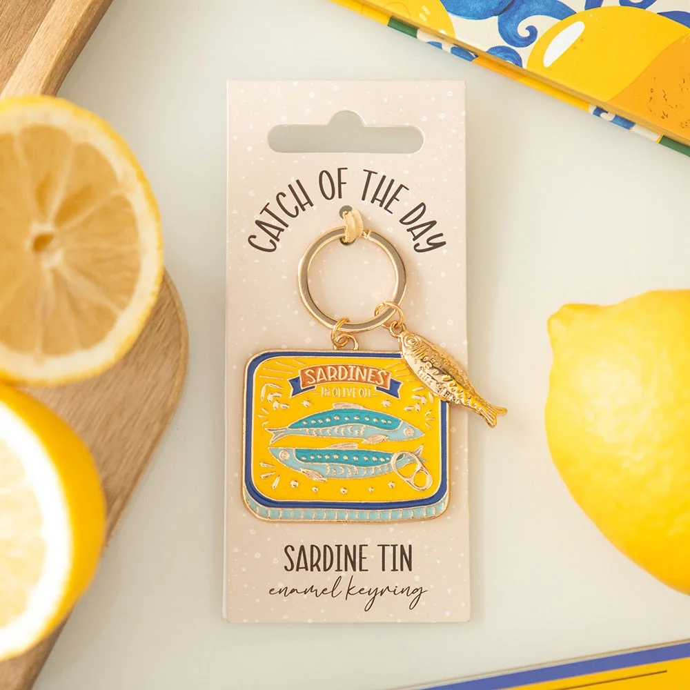 Enamel sardine tin keyring in silver and blue, shaped like a classic sardine tin with detailed lid design
