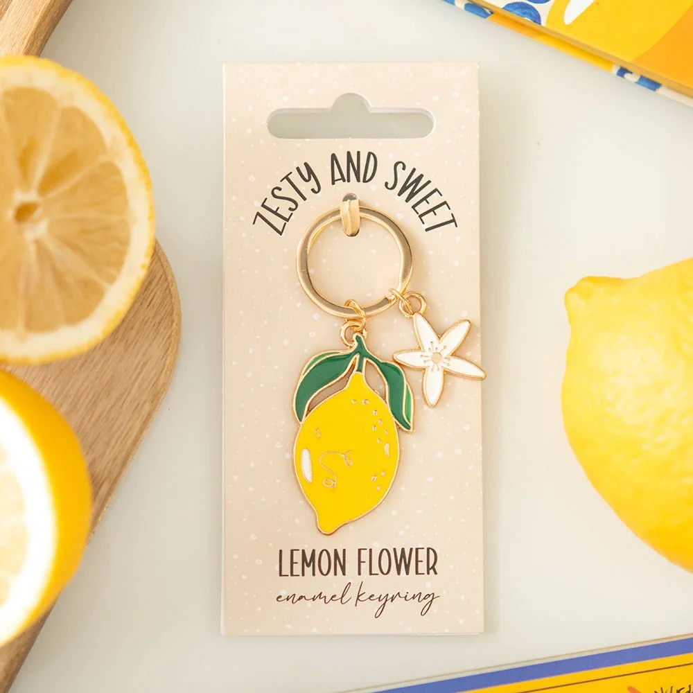 Lemon flower keyring with enamel design showing a delicate yellow lemon blossom on a silver keyring loop