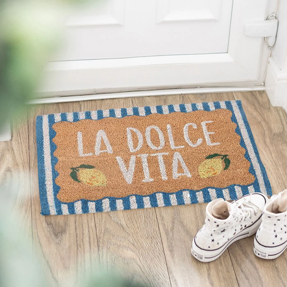 blue coir doormat with blue borders, lemon motifs and the phrase 'La Dolce Vita