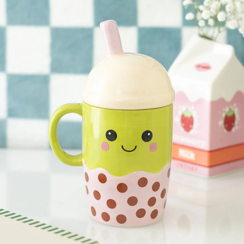 Ceramic bubble tea mug with pastel pink straw, domed lid, and smiling face – charming kawaii design.