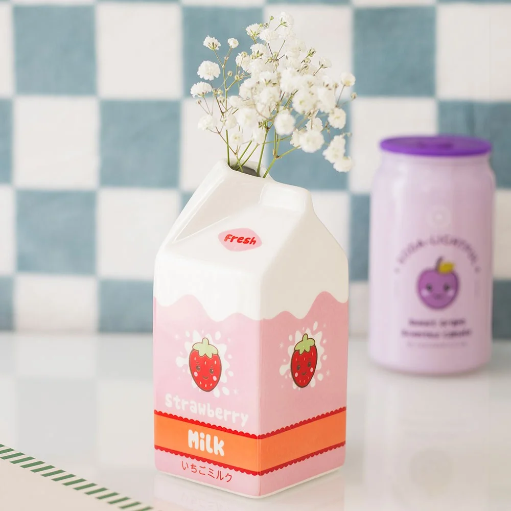Kawaii strawberry milk vase with smiling face, ceramic design resembling a strawberry milk carton, perfect as a cute flower holder.