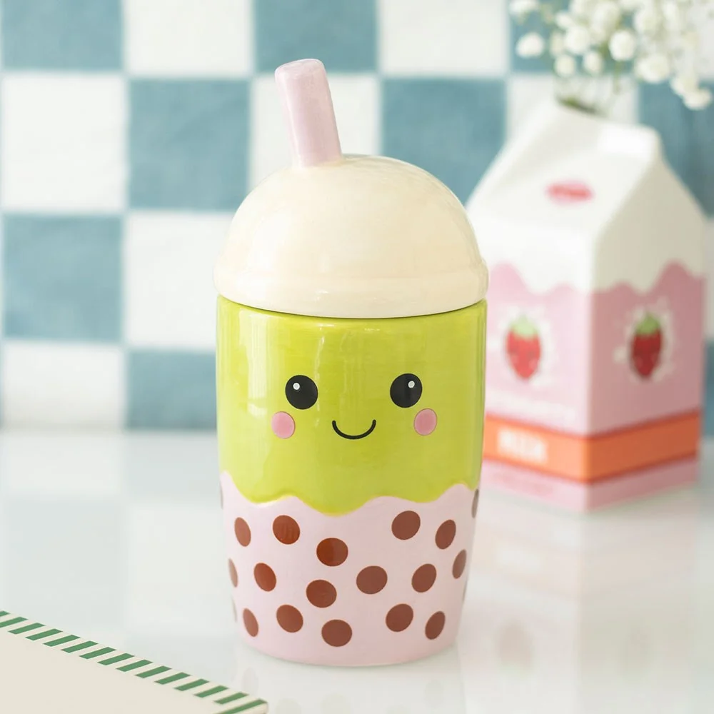 Ceramic bubble tea oil burner with heart‑shaped cut‑outs and removable lid shown with a tealight inside in bubble‑tea theme.