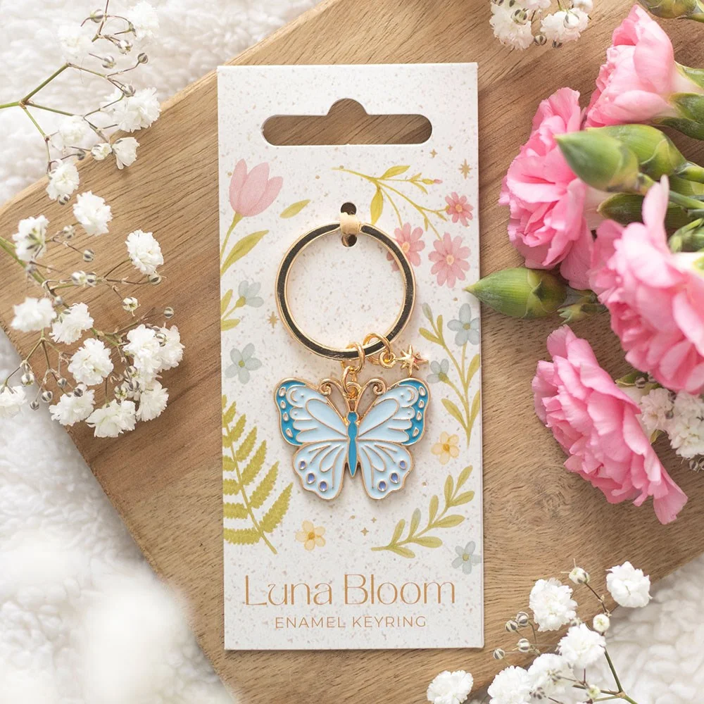 Pastel blue enamel butterfly keyring with delicate wings on a silver ring, perfect spring accessory