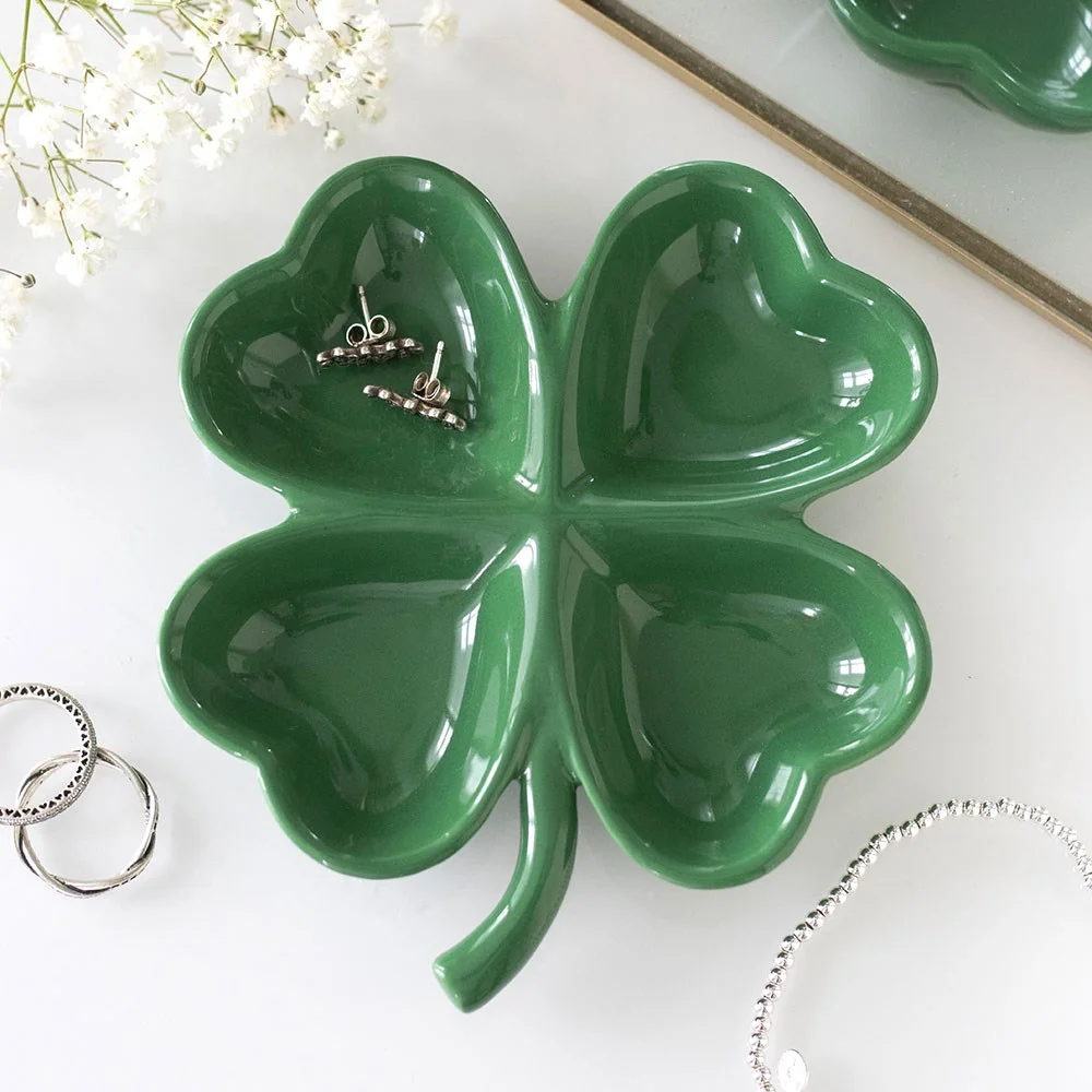 Glossy green ceramic four leaf clover tray holding jewellery, coins & treasures—ideal for St. Patrick's Day or luck.