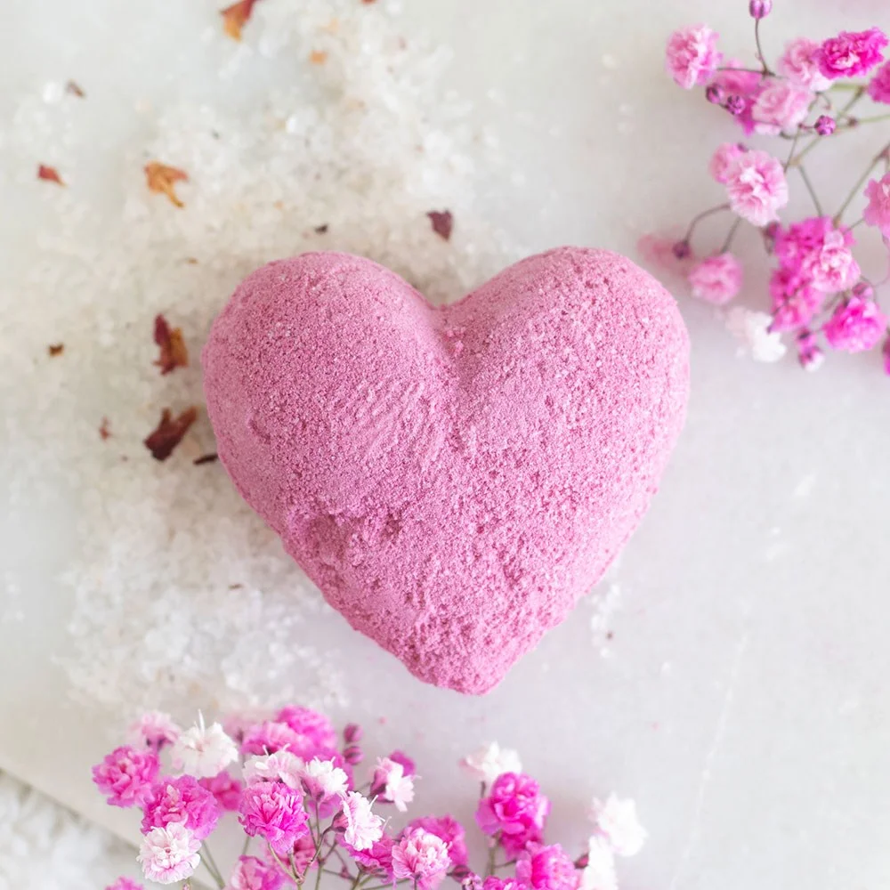 Heart shaped bath bomb in bright red with a cherry theme, handmade, vegan, and cruelty-free from the UK.