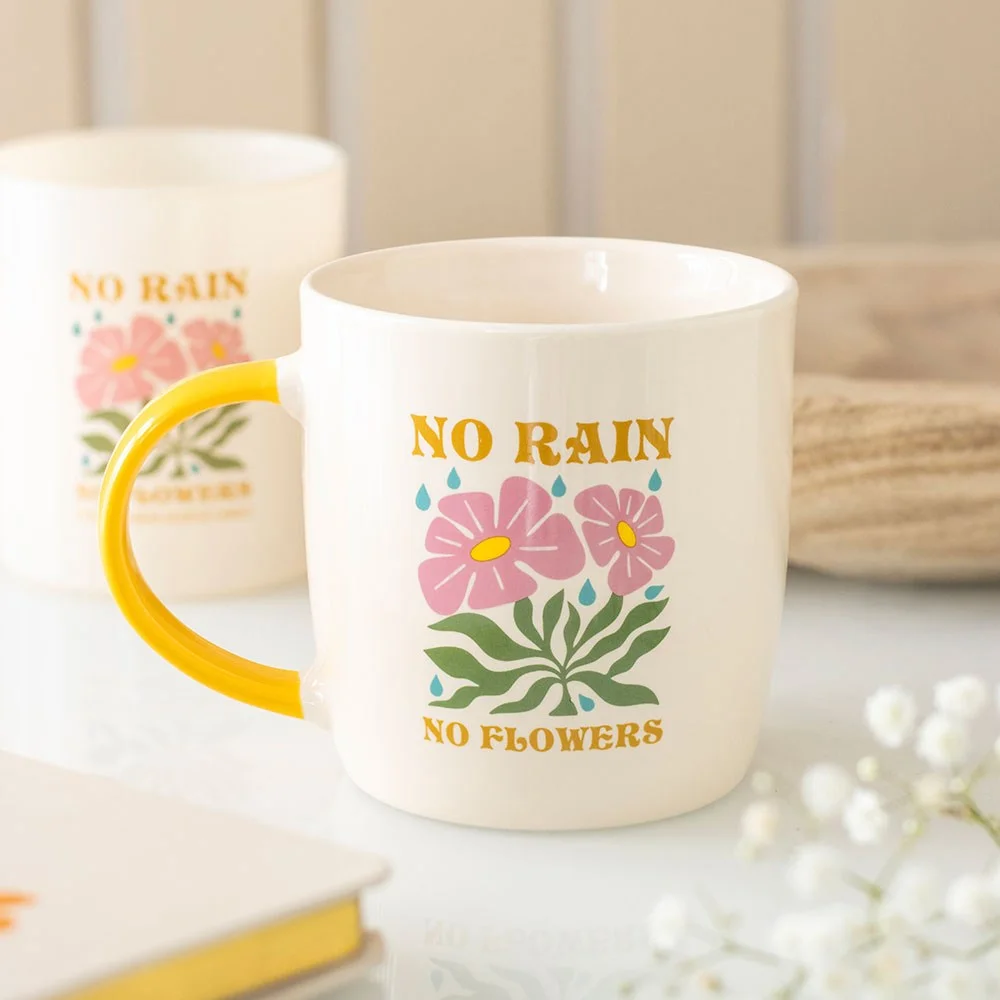 Vibrant No Rain No Flowers mug with colourful design and yellow handle