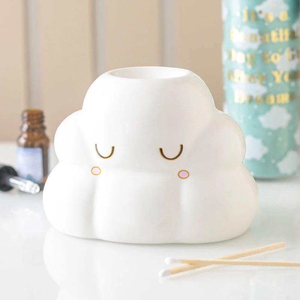 Cloud shaped oil burner with a soft cloud silhouette, tealight inside and a drop of fragrance oil at its base.