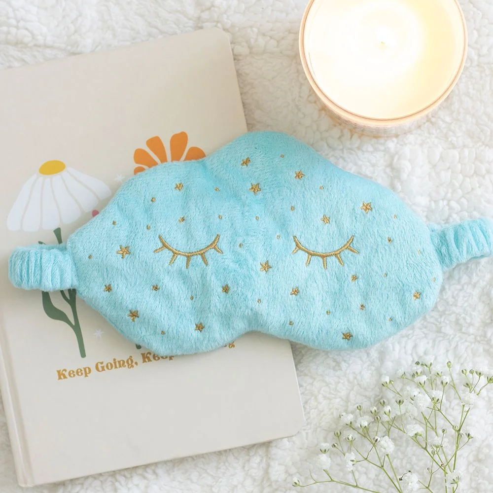 Soft cloud-shaped sleep mask adorned with sleepy lashes, ready for travel naps.