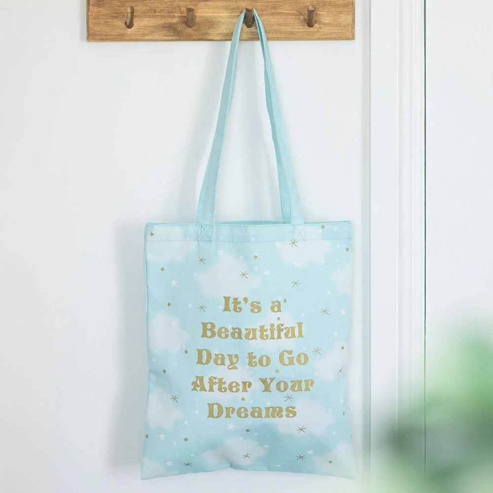 Soft cloud print tote bag showing cloud pattern and uplifting message, suitable for school, beach, yoga.