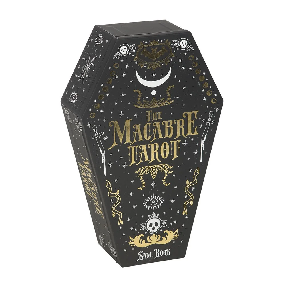 Coffin-shaped box and spread of 78 cards from the macabre tarot deck with dark, shadowy artwork and guidebook visible