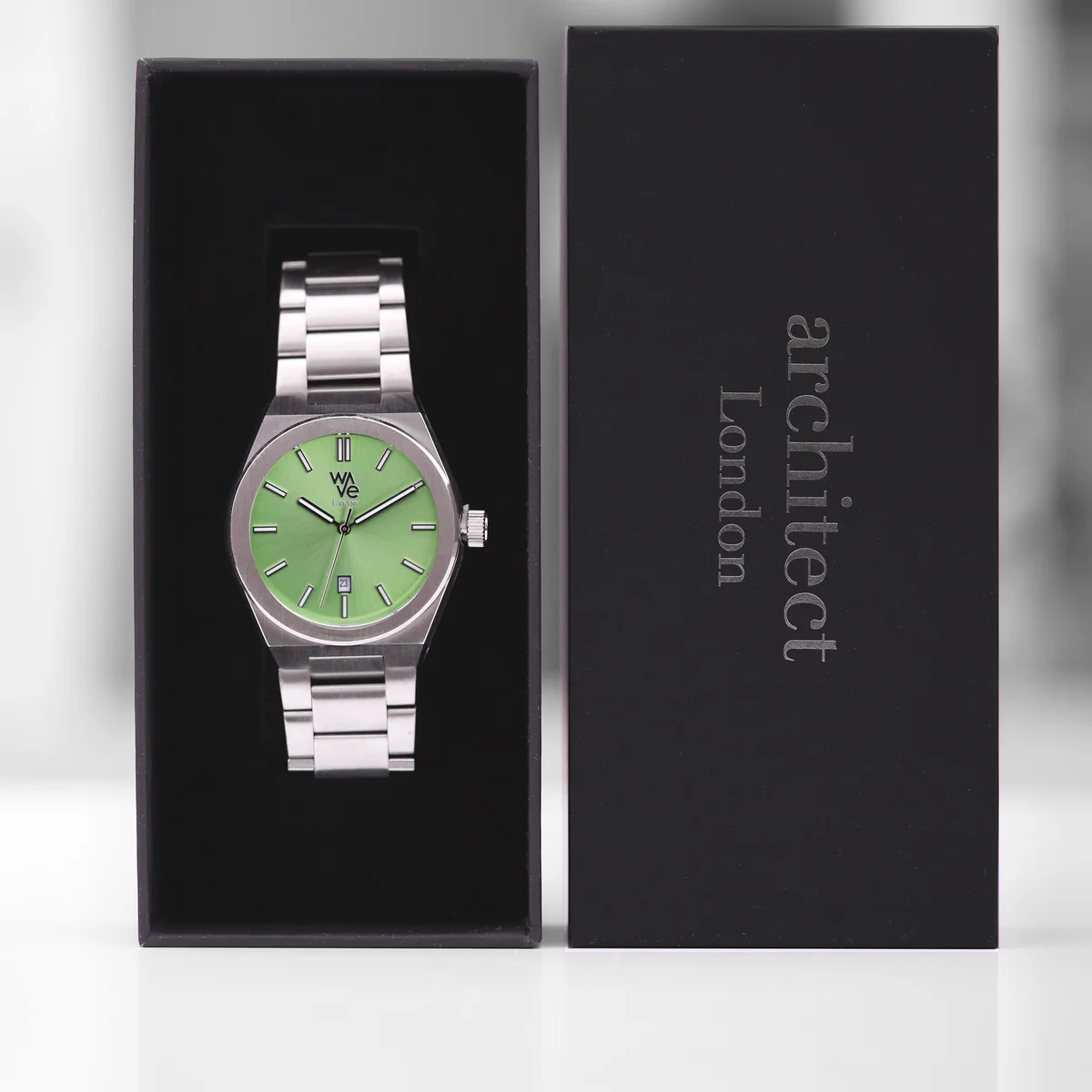 Minimalist mens watch in vibrant lime green with stainless steel band and personalized handwriting engraving on back