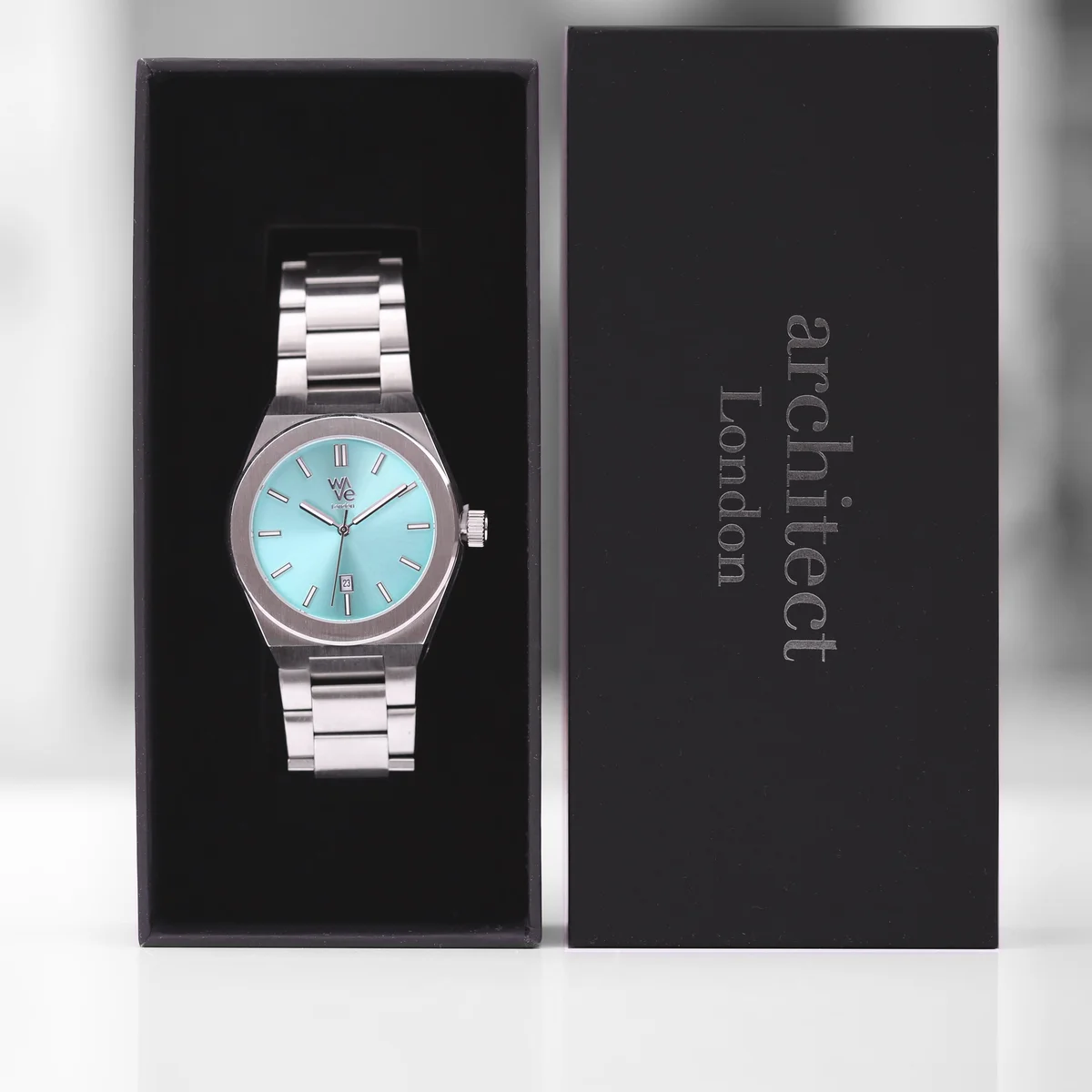 Ocean Blue Wave Watch Collection timepiece with stainless steel band and luminous dial on white background
